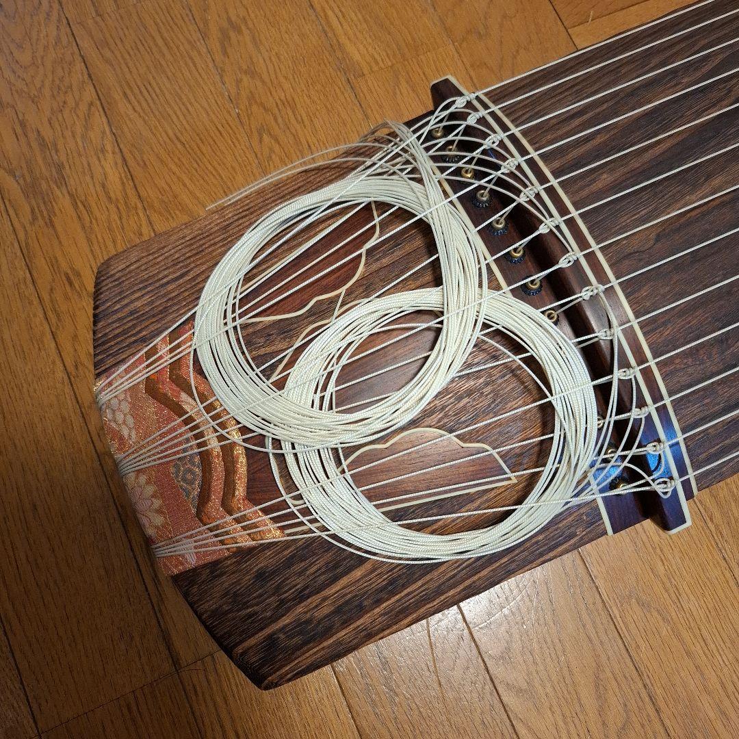 オレンジ色の鶴模様の袋つき　　　お琴