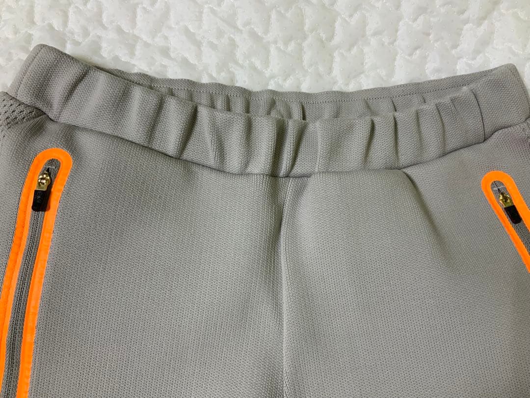 マークアンドロナレディースパンツ オレンジジッパー