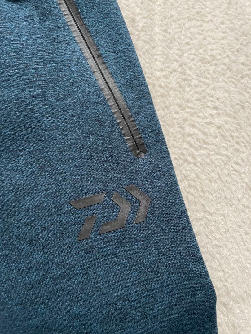 ダイワ　DAIWA ウィンドブロックジョガーパンツ　XLサイズ　フェザーブルー