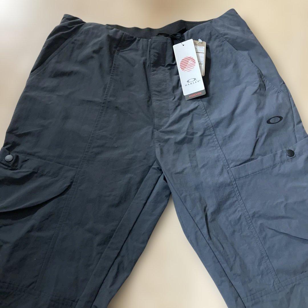 新品未使用タグ付きOAKLEYマットチャコールグレーピステウィンドブレーカーXL